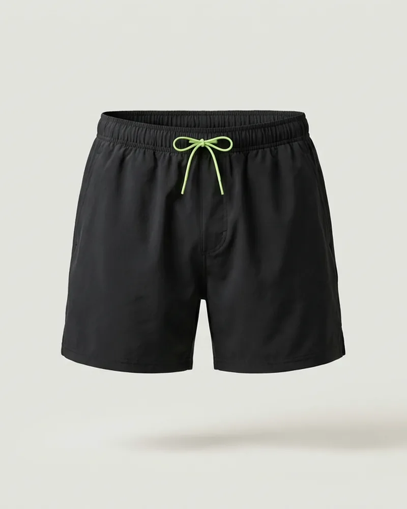 Black running shorts with a lime drawcord on a pale grey background