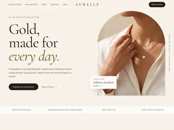Aurelle concept home page, a hand wearing gold rings in an arched frame beside a fine serif headline.